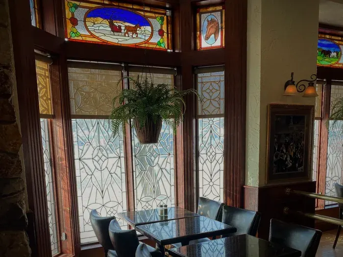 Stained-glass windows and leaded glass over the tables in the Hob-Nob Lounge